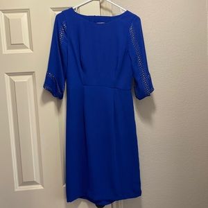 BCBG blue cocktail dress. Back cutout. Brass details w/3/4 sleeves. Size small.